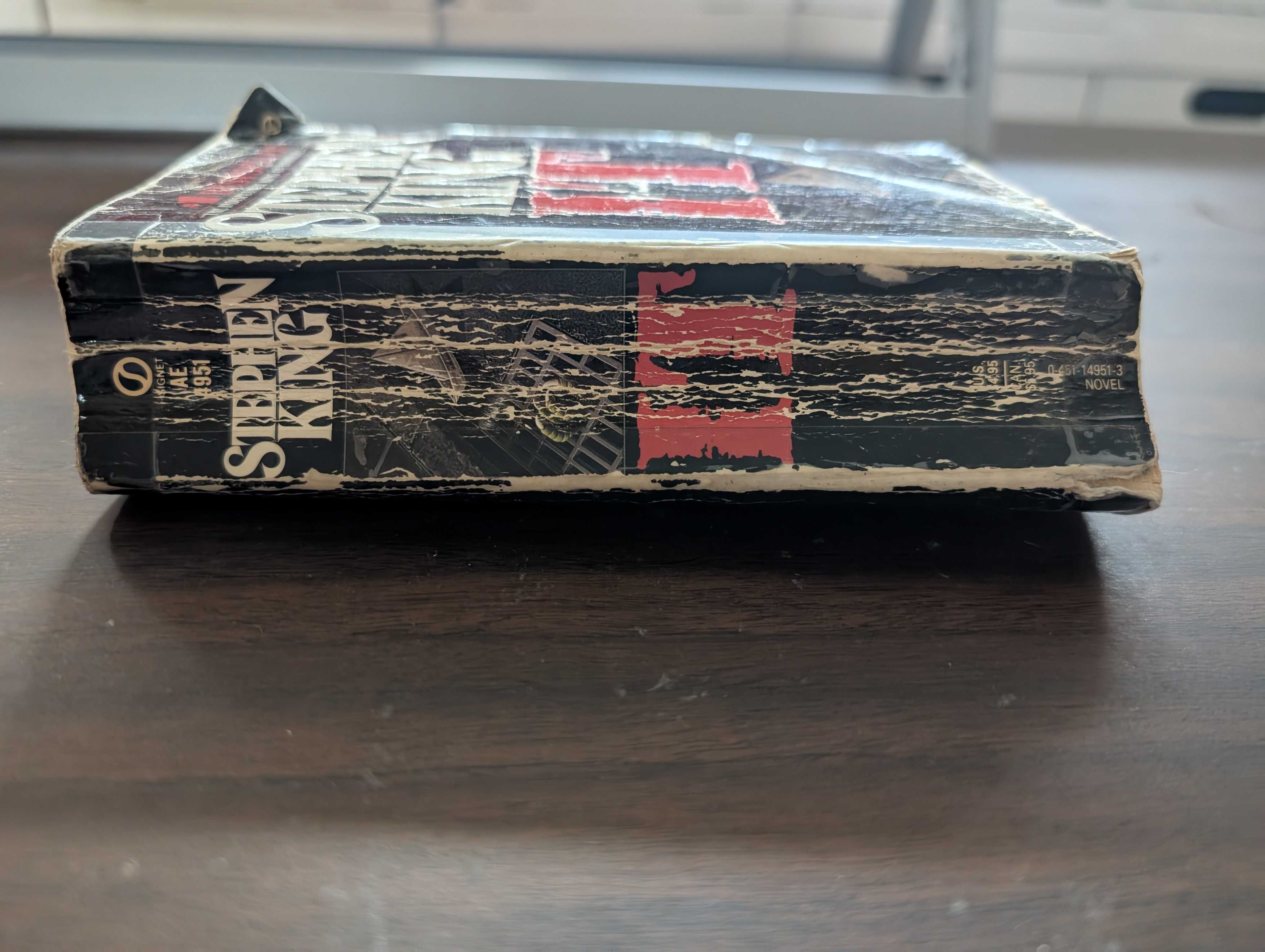 Heavily creased and worn spines where it is difficult to read the title or author's name